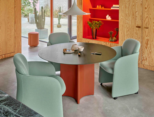 Leolux Conka Round dining table in solid oak and base in leather in modern interior with dining chairs