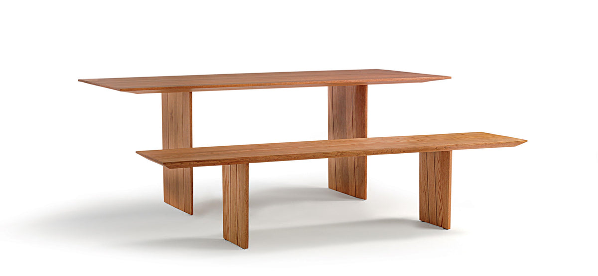 Incastro contemporary dining table , featuring a warm solid oak wood and a minimalist design, shown with Incastro bench