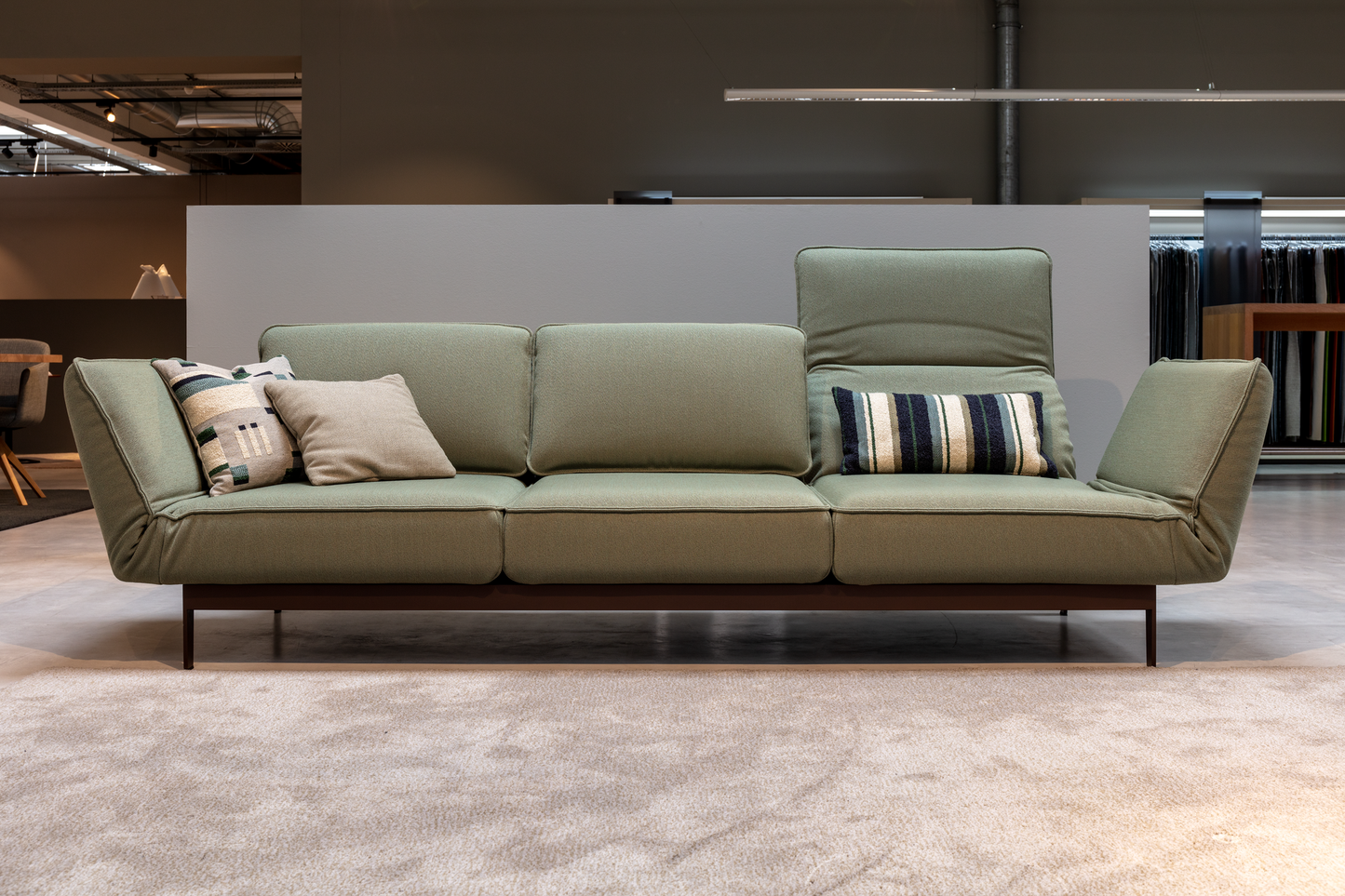 Rolf Benz Mera Green sofa with mechanism in a modern indoor setting