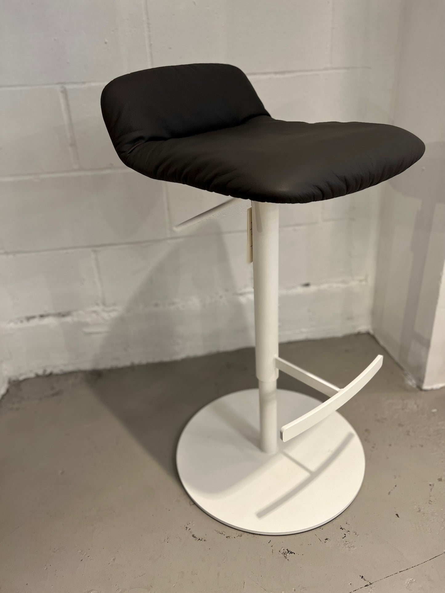 Leya Low Back Stool in anthracite leather and adjustable height column base in white